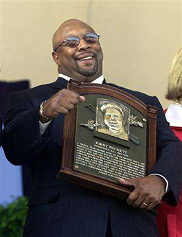 Kirby Puckett holding his Hall of Fame Plaque at the induction ceremony in Cooperstown.